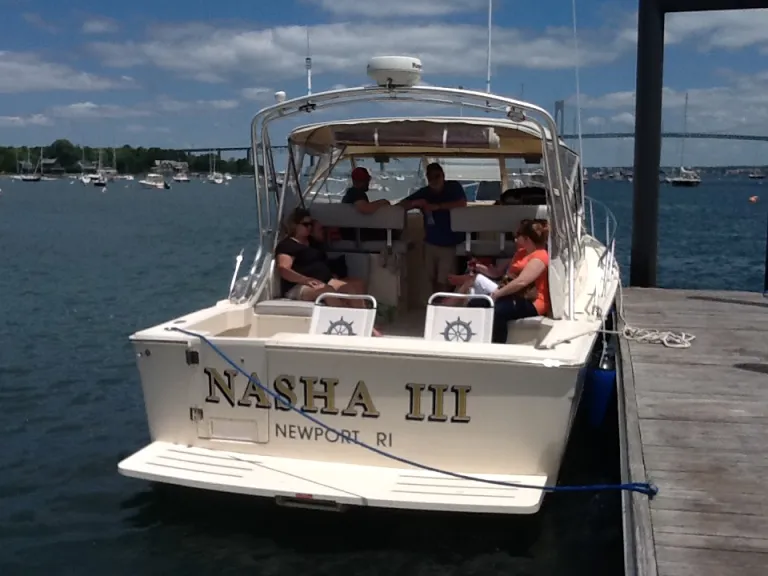 IMG_1617 A group of people sitting on the back of a boat.