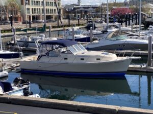 A boat is docked in the water at a marina.
